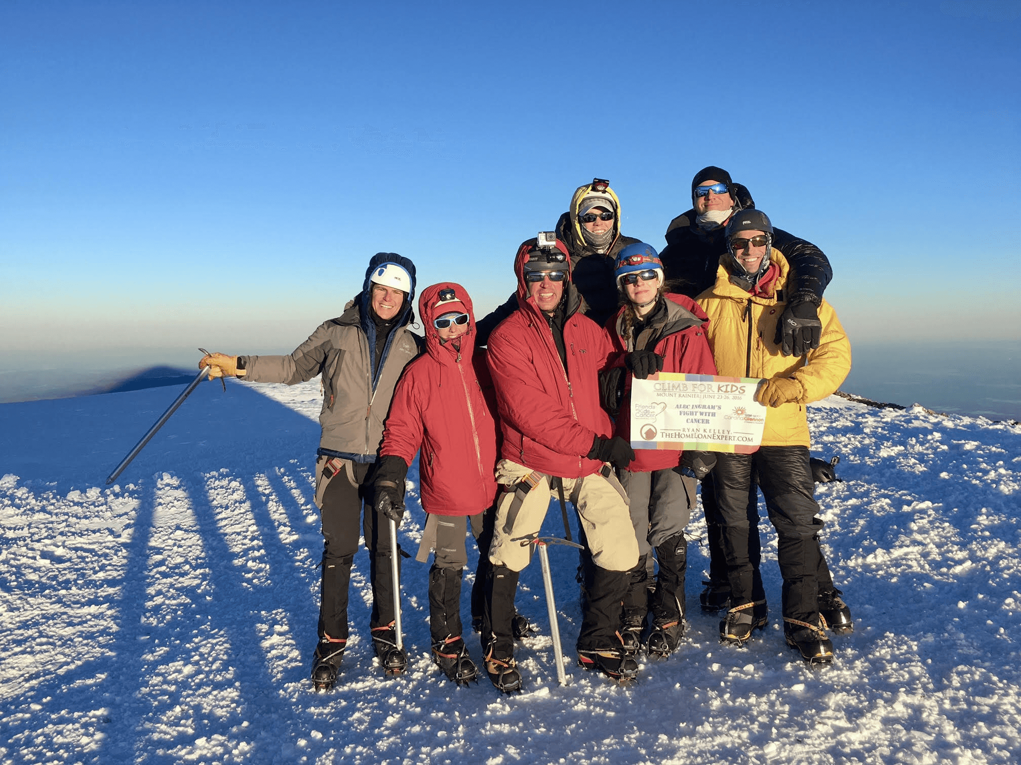 Climb For The Kids team members standing together on a snowy summit.